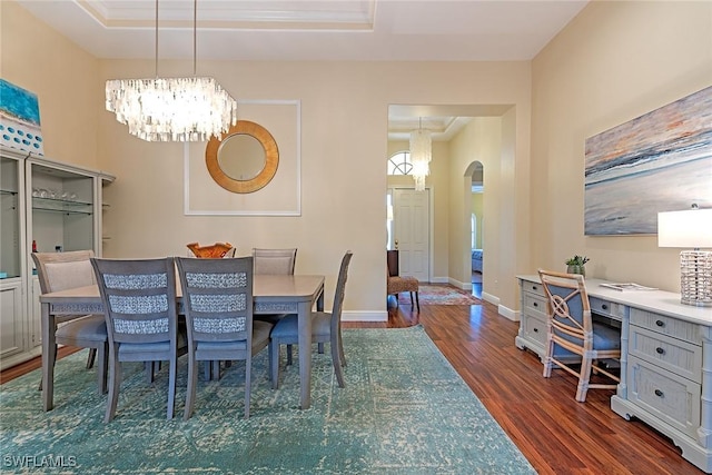 dining space with arched walkways, baseboards, a chandelier, and dark wood-style floors
