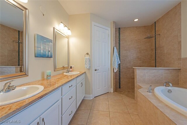 full bathroom with tile patterned flooring, a sink, and a walk in shower