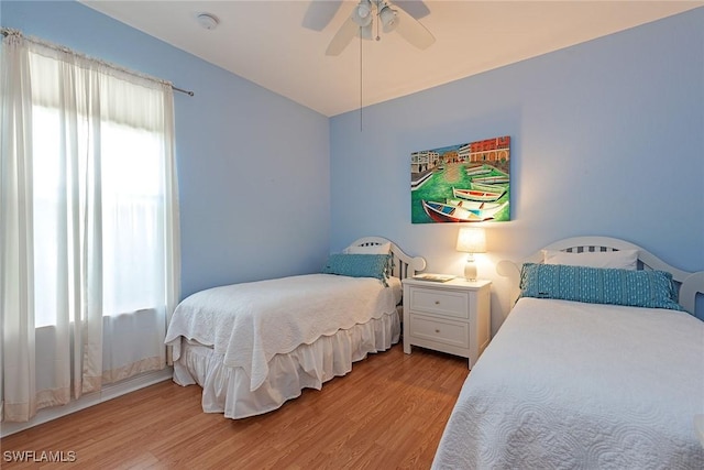 bedroom with light wood-style flooring and a ceiling fan