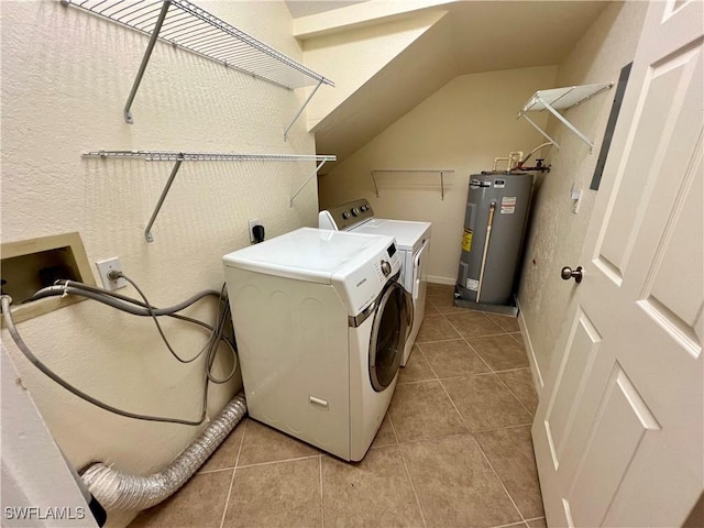 washroom with separate washer and dryer, laundry area, light tile patterned flooring, and water heater