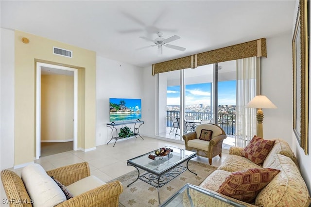tiled living area with baseboards, a ceiling fan, and visible vents