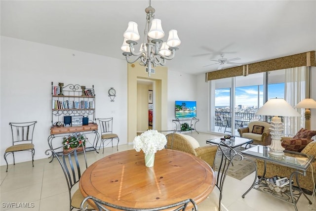 dining area with ceiling fan with notable chandelier and light tile patterned flooring