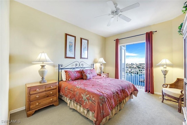 bedroom with baseboards, access to outside, a ceiling fan, and light colored carpet