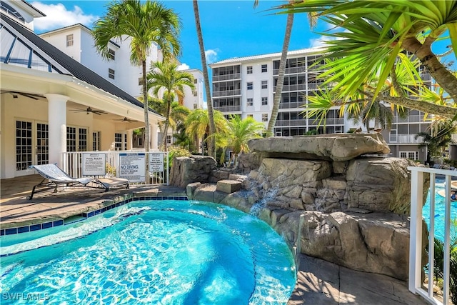 view of swimming pool featuring ceiling fan