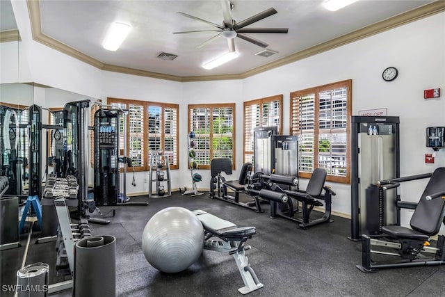 gym with visible vents, a ceiling fan, baseboards, and crown molding