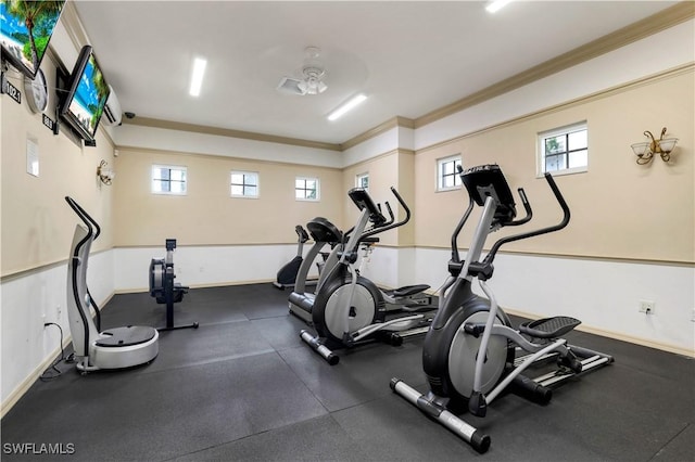 gym with crown molding and baseboards