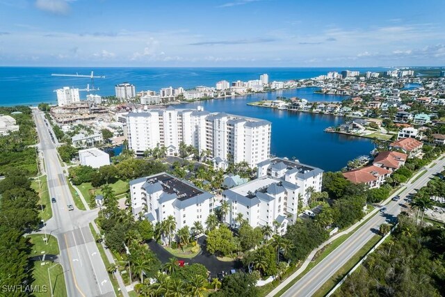 aerial overview of property's location featuring a nearby body of water, apartment complex / building, and nearby urban area