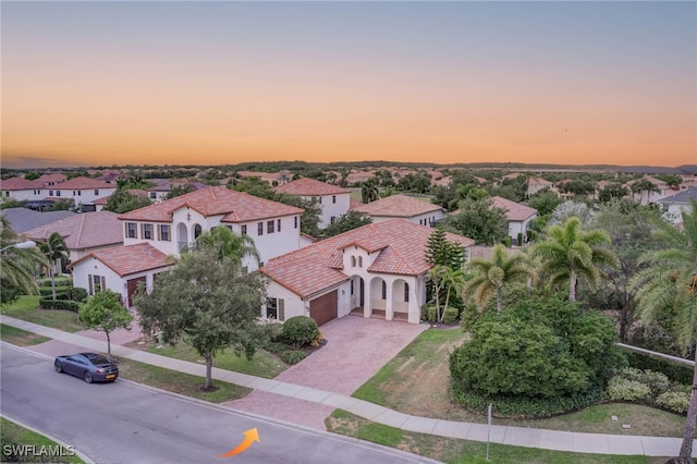 aerial view at dusk featuring a residential view