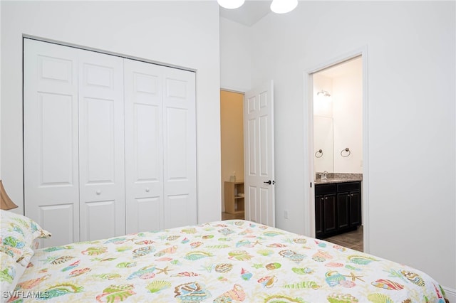 bedroom featuring a sink, a closet, and ensuite bath