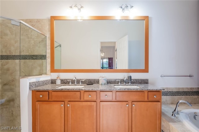 full bathroom with a sink, double vanity, a tile shower, and a garden tub