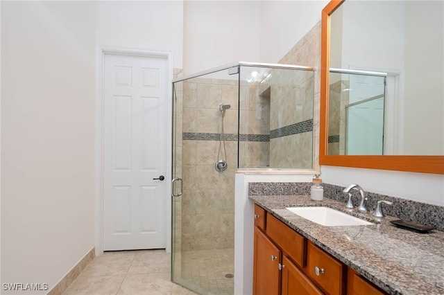 full bath featuring vanity, tile patterned flooring, and a stall shower