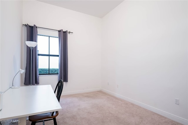 unfurnished office with baseboards and carpet flooring
