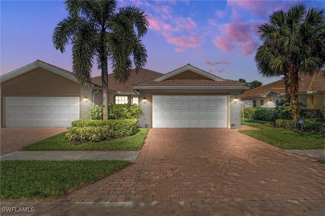 3695 Exuma Way, Naples, FL 34119 - ranch-style home featuring an attached garage, decorative driveway, stucco siding, and a tile roof
