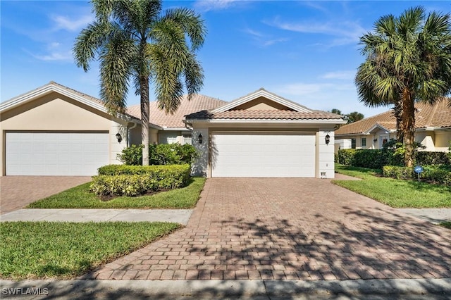 3695 Exuma Way, Naples, FL 34119 - ranch-style home featuring a garage, stucco siding, a tile roof, and decorative driveway