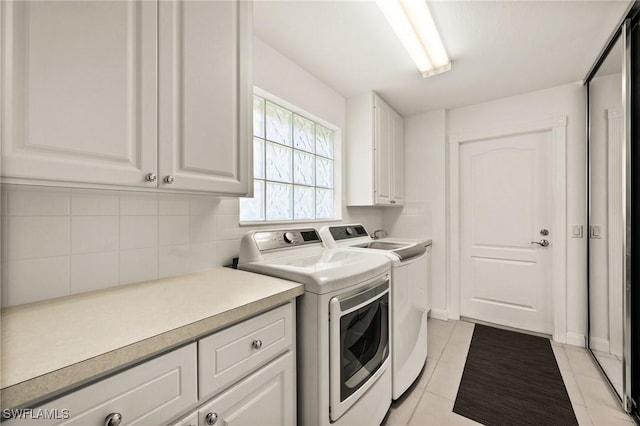 3695 Exuma Way, Naples, FL 34119 - laundry area with cabinet space, light tile patterned flooring, and washing machine and dryer