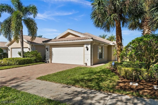 3695 Exuma Way, Naples, FL 34119 - ranch-style home with a garage, stucco siding, a tile roof, and decorative driveway