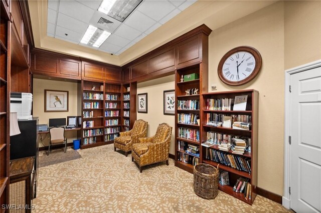 3695 Exuma Way, Naples, FL 34119 - living area featuring carpet floors, baseboards, wall of books, and visible vents