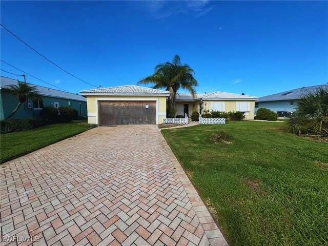 12 Bayview Blvd, Fort Myers Beach, FL 33931 - ranch-style home with stucco siding, decorative driveway, a front yard, and a garage