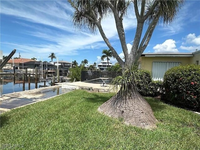 12 Bayview Blvd, Fort Myers Beach, FL 33931 - view of yard with a water view, boat lift, and a dock