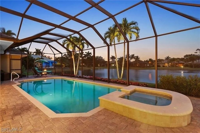 4009 Treadwater Ct, Naples, FL 34109 - pool at dusk with a patio, a water view, a lanai, and a pool with connected hot tub