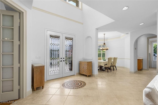 4009 Treadwater Ct, Naples, FL 34109 - entryway with baseboards, arched walkways, light tile patterned flooring, and french doors