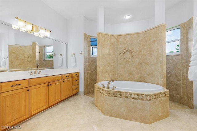 4009 Treadwater Ct, Naples, FL 34109 - full bathroom with tile patterned flooring, a garden tub, a wealth of natural light, and vanity