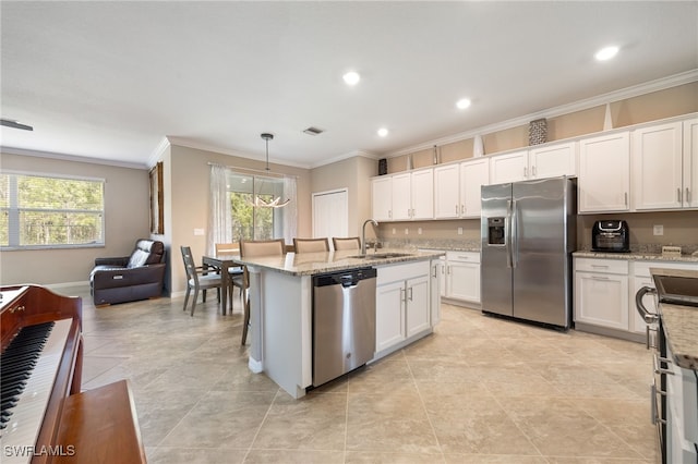 kitchen with ornamental molding, stainless steel appliances, white cabinets, and a sink