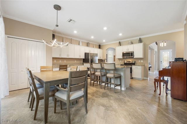 dining space with arched walkways, recessed lighting, crown molding, and visible vents