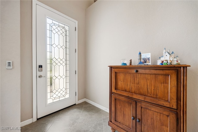 foyer with baseboards and light tile patterned flooring