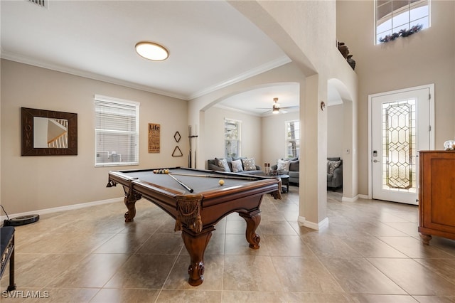 playroom featuring ornamental molding, tile patterned floors, arched walkways, billiards, and baseboards