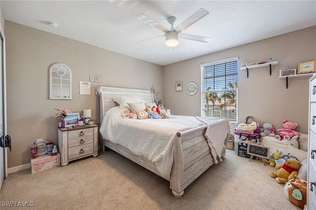 bedroom with a ceiling fan and light colored carpet