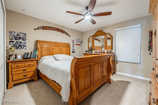 bedroom with baseboards, light carpet, and ceiling fan