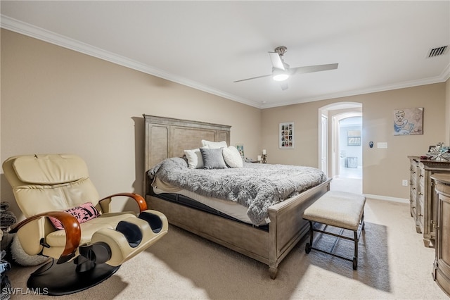 bedroom with baseboards, visible vents, crown molding, arched walkways, and light colored carpet