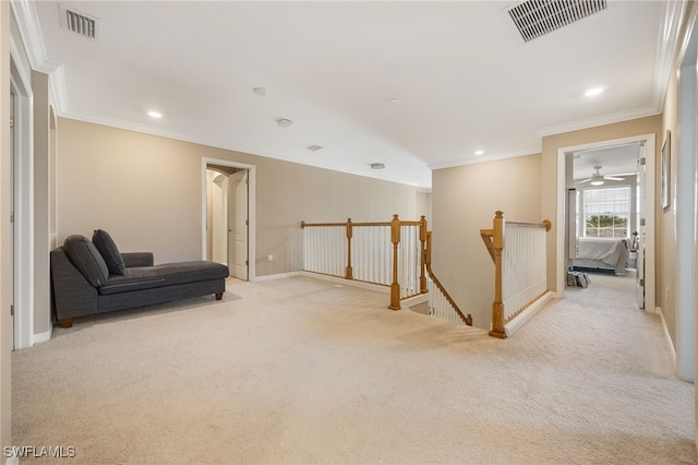 living area featuring crown molding, visible vents, an upstairs landing, and light carpet