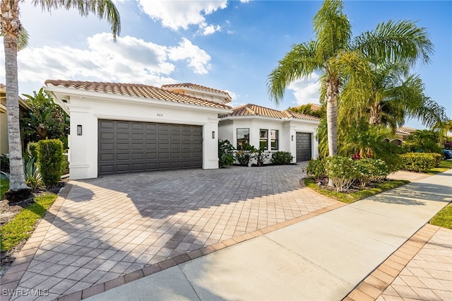 3412 Atlantic Cir, Naples, FL 34119 - mediterranean / spanish-style home with stucco siding, decorative driveway, a tile roof, and a garage