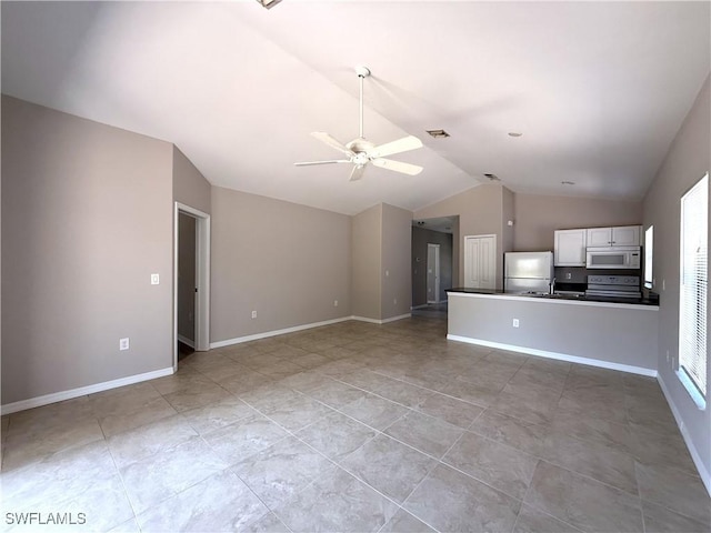 unfurnished living room featuring visible vents, a sink, light tile patterned flooring, a ceiling fan, and vaulted ceiling