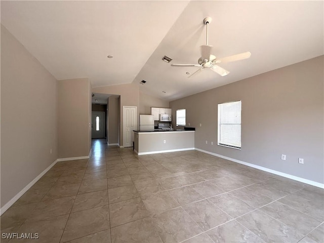unfurnished living room with visible vents, light tile patterned flooring, baseboards, a ceiling fan, and vaulted ceiling