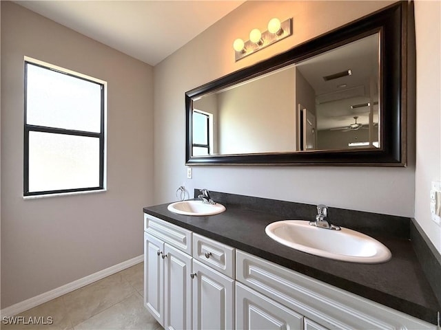bathroom with plenty of natural light, a sink, and baseboards
