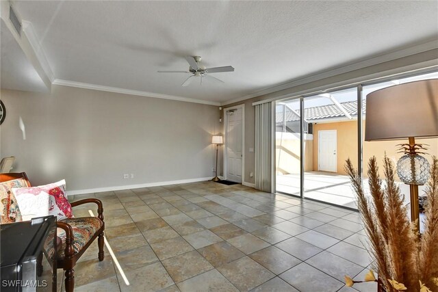 sitting room featuring crown molding, a ceiling fan, baseboards, and visible vents