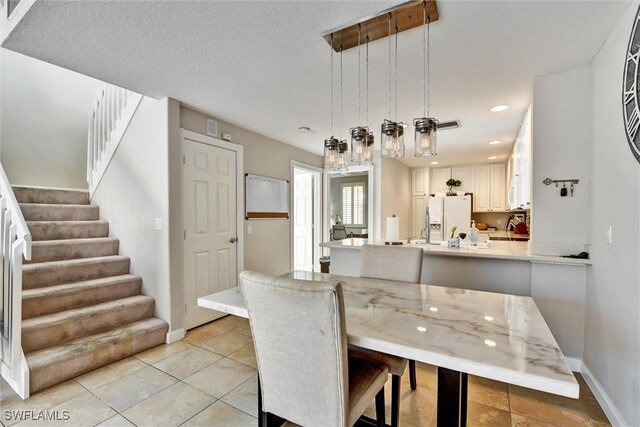 dining area with baseboards, recessed lighting, stairs, and light tile patterned floors