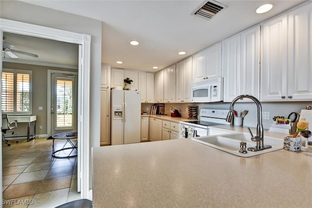 kitchen featuring white cabinets, a sink, white appliances, recessed lighting, and visible vents