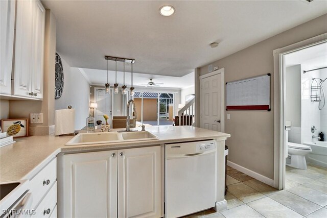 kitchen featuring ceiling fan, white dishwasher, light tile patterned floors, a sink, and a peninsula