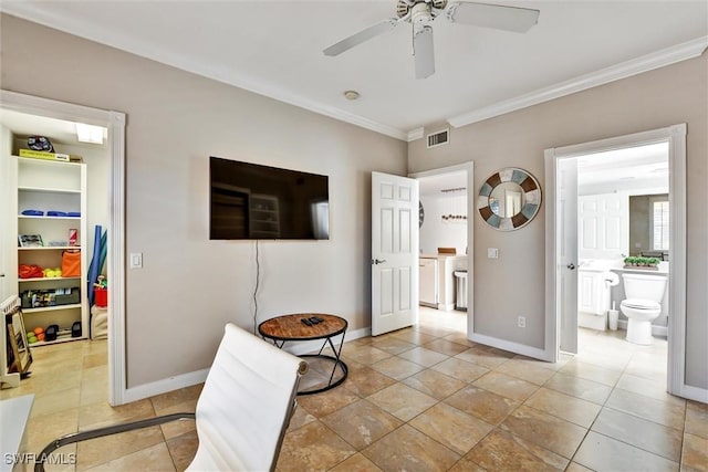 interior space featuring crown molding, visible vents, baseboards, ensuite bathroom, and a spacious closet