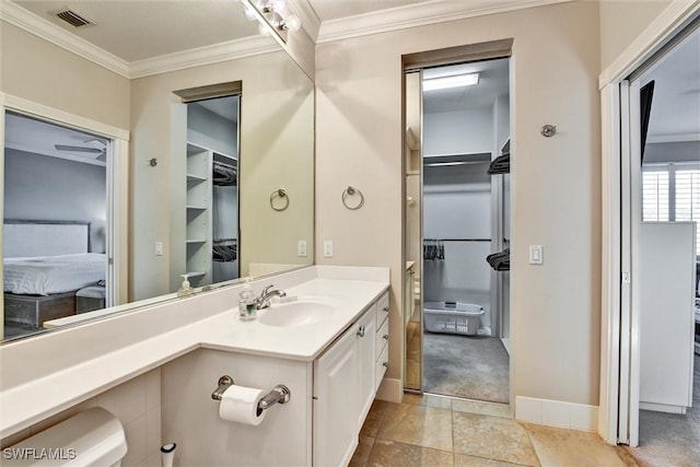 bathroom featuring crown molding, baseboards, visible vents, and vanity