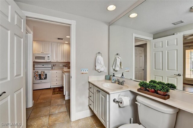 bathroom with visible vents, baseboards, toilet, and vanity