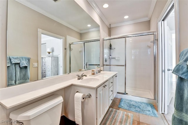 full bathroom featuring tile patterned flooring, a sink, ornamental molding, and a shower stall