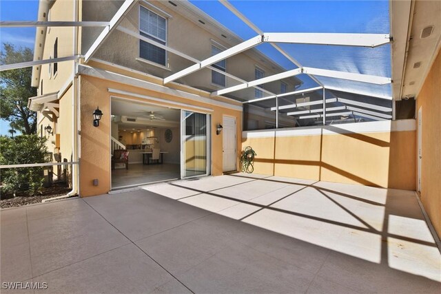view of patio featuring glass enclosure