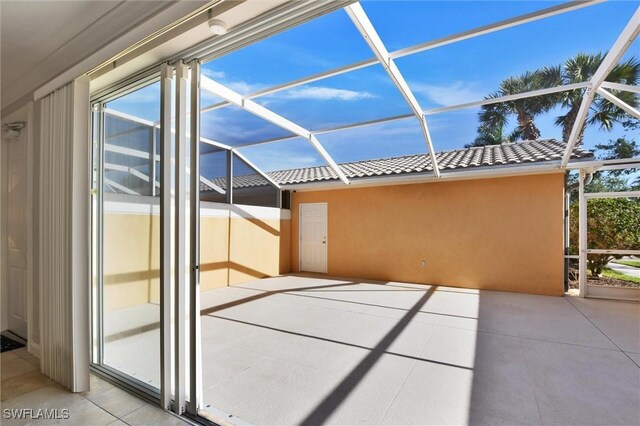 view of patio with glass enclosure