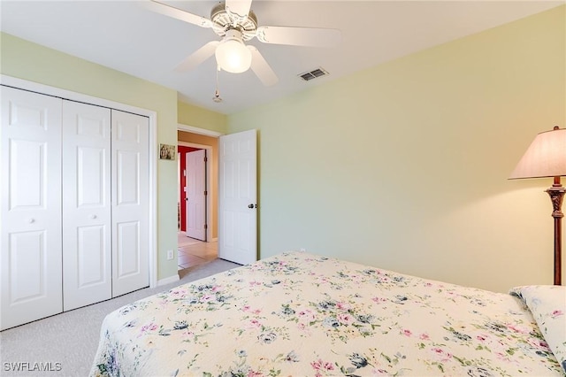 3775 Fieldstone Blvd Unit 104, Naples, FL 34109 - bedroom featuring visible vents, a ceiling fan, a closet, and light carpet