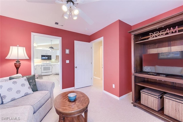 3775 Fieldstone Blvd Unit 104, Naples, FL 34109 - living area with visible vents, baseboards, ceiling fan, and light colored carpet